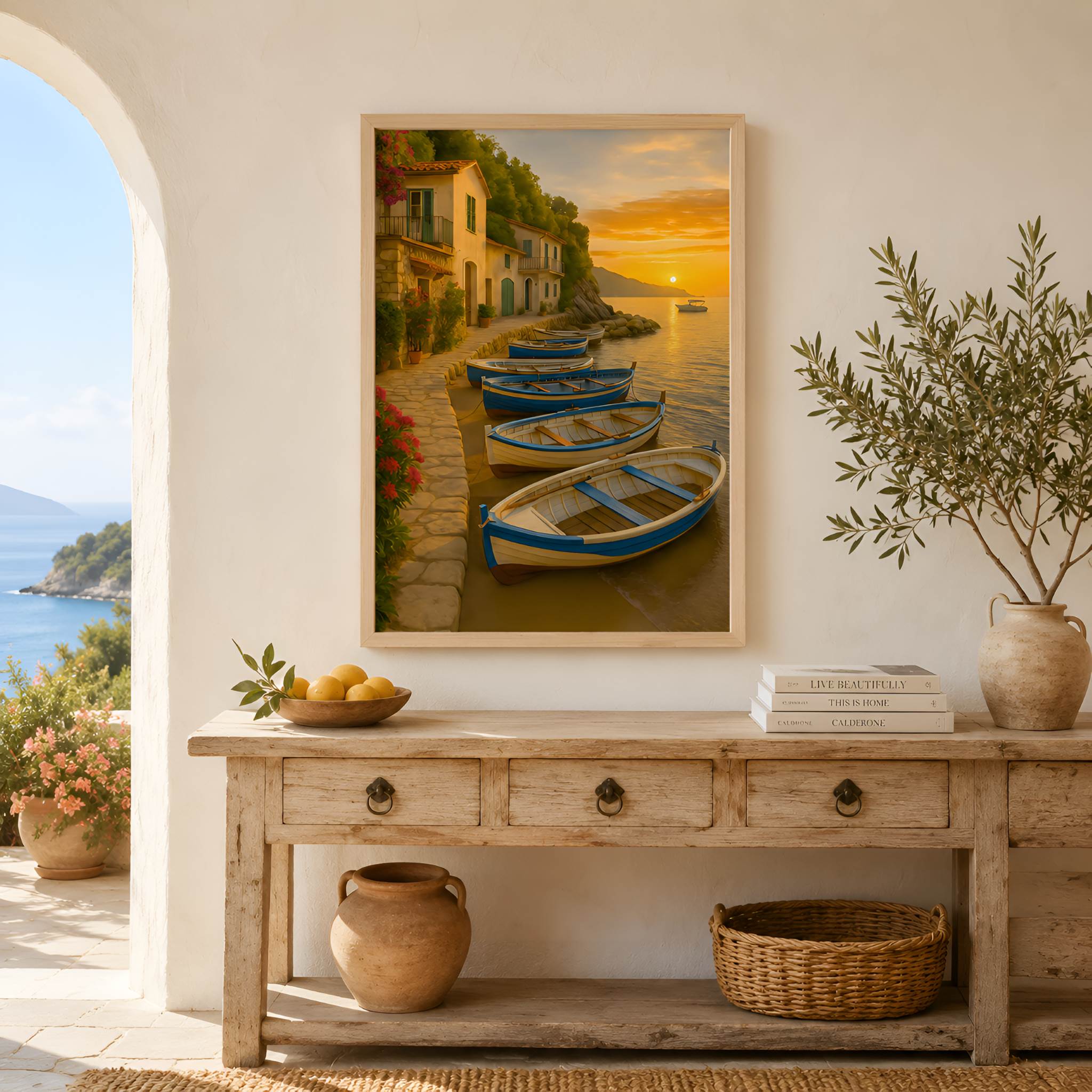 Framed Mediterranean artwork of boats on a dock with a sunset, displayed above a wooden console table.