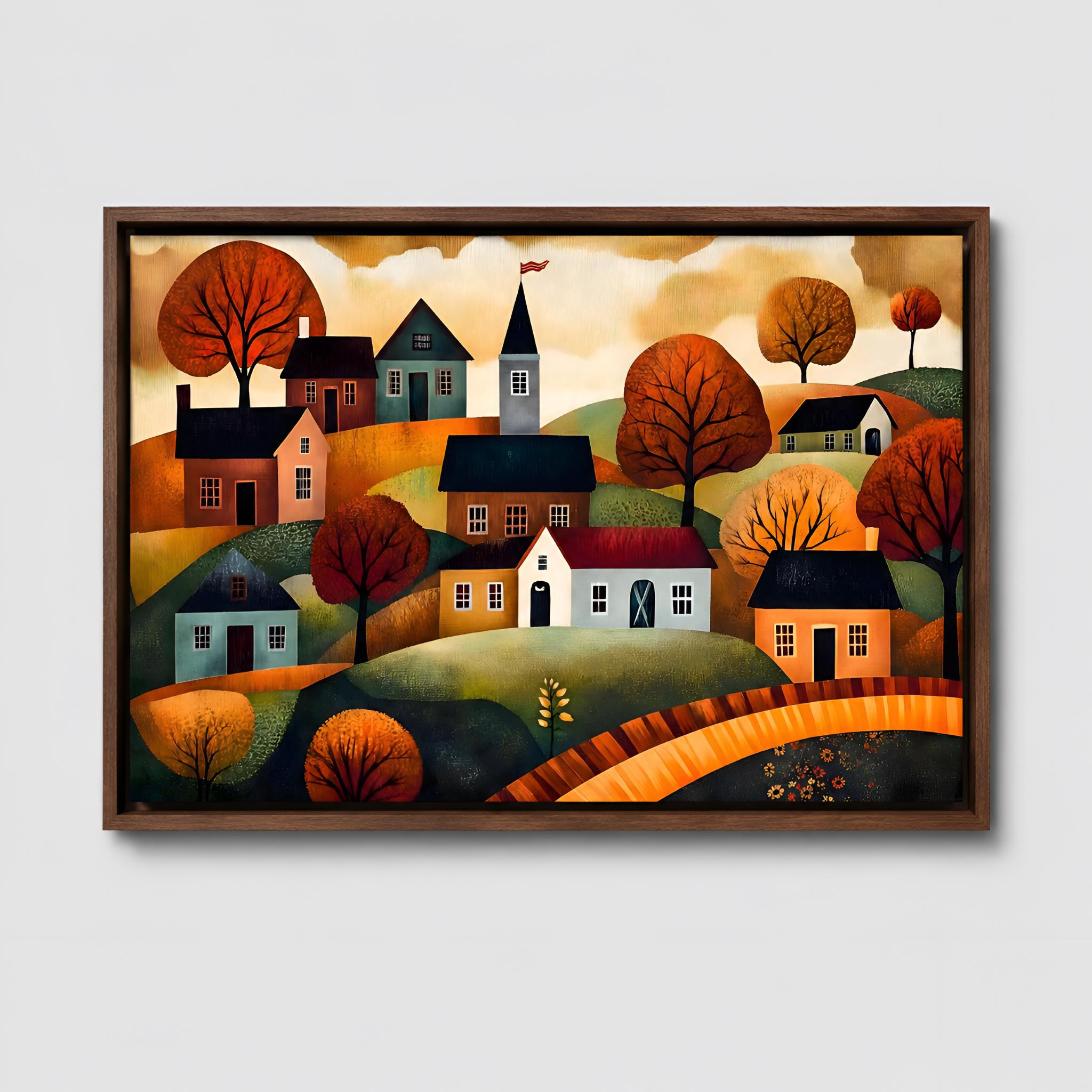 Walnut framed Autumn artwork of a colorful village scene with houses and trees on a white wall.