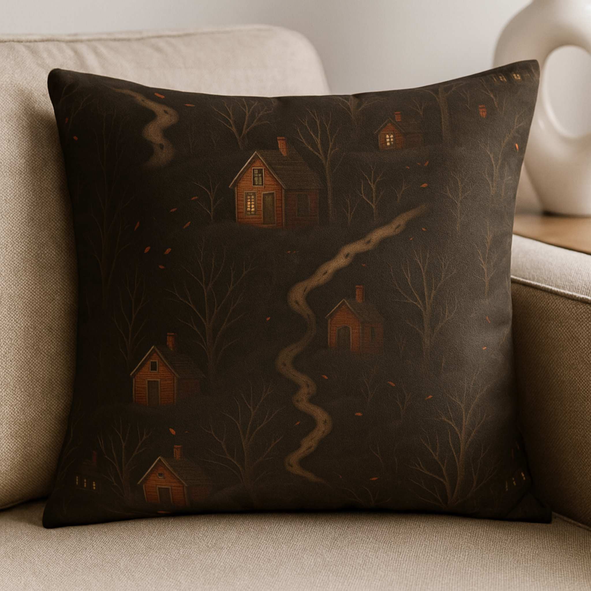 Decorative autumn throw pillow with house pattern on a beige couch