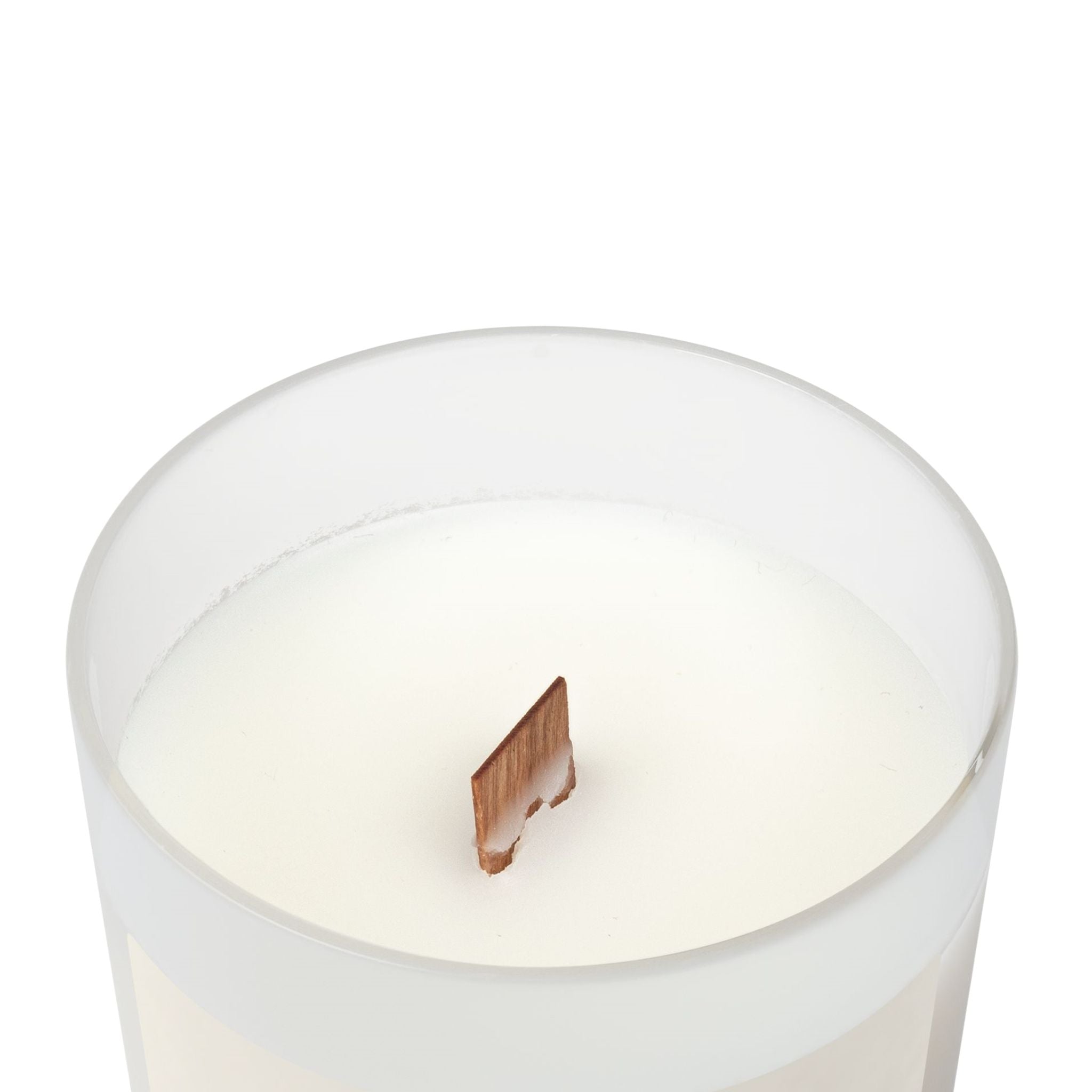 Closeup of a candle with vegan apricot and coconut wax blend featuring a wooden wick.