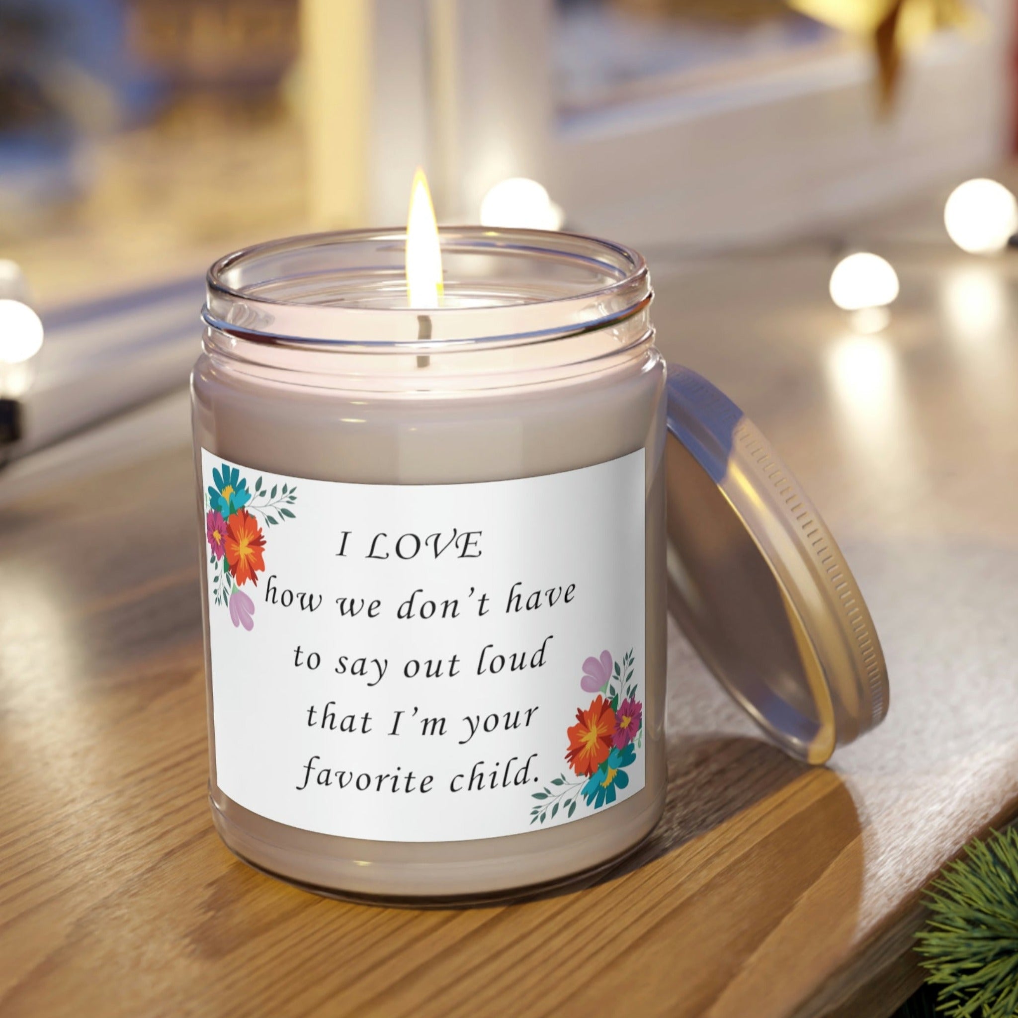 Favorite Child Scented Candle, Eco-Friendly Soy Wax, 9oz sitting on shelf with open lid and lit flame.